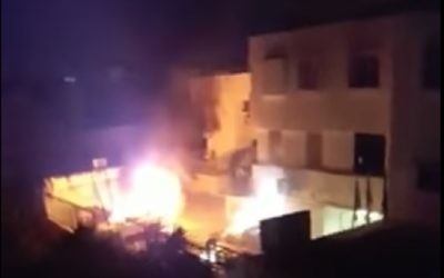 Police cars set on fire in Kafr Kassem on June 6, 2017. (screen capture: YouTube)