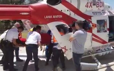 Medics transport the body of an 18-year-old found dead in Ramle on June 13, 2017, with multiple stab wounds to her upper torso. (YouTube screenshot/MDA)