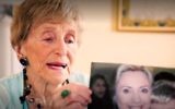 Sara Ehrman, who died aged 98, holding up a photograph of herself with Hillary Clinton, October 28, 2016. (New York Times screenshot)