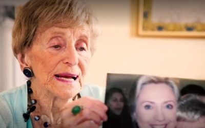 Sara Ehrman, who died aged 98, holding up a photograph of herself with Hillary Clinton, October 28, 2016. (New York Times screenshot)
