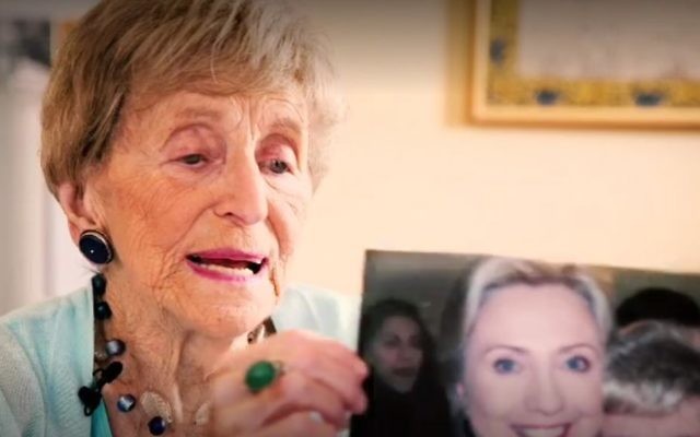 Sara Ehrman, who died aged 98, holding up a photograph of herself with Hillary Clinton, October 28, 2016. (New York Times screenshot)