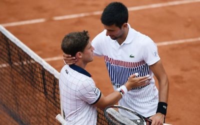 Diego Schwartzman, left, is congratulated by Novak Djokovic after their thrilling five-set French Open match in Paris won by Djokovic, June 2, 2017. (Lionel Bonaventure/AFP/Getty Images via JTA) Diego Schwartzman, left, is congratulated by Novak Djokovic after their thrilling five-set French Open match in Paris won by Djokovic, June 2, 2017. (Lionel Bonaventure/AFP/Getty Images via JTA)