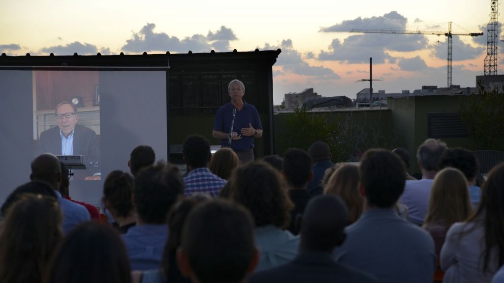 Joey Low, founder and director of Israel at Heart which sponsors many of the students, addresses the crowd at the African Student Organization launch event at WeWork in South Tel Aviv on June 21, 2017. (courtesy Eli Tesma) 