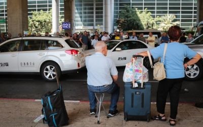 Passengers wait at Ben Gurion Airport, just outside Tel Aviv, as taxi drivers protest a 12 percent discount on fares introduced by management, June 12, 2017. (FLASH90)