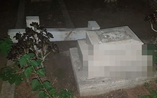 A tombstone vandalized in the Templar Cemetery in Haifa (Israel Police)
