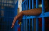 A drug addict stands behind bars at a Hamas-run prison in Gaza City on May 10, 2017. (AFP Photo/Mohammed Abed)