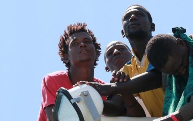 Migrants wait to disembark from the Spanish Guardia Civil Rio Segura Patrol Ship with 1,216 migrants onboard including 256 children and 11 pregnant women, who were rescued in the Mediterranean sea on June 29, 2017, in the port of Salerno, Italy (AFP PHOTO / CARLO HERMANN)