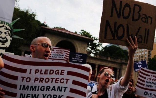 People take part in a rally to protest restrictive guidelines issued by the US on who qualifies as a close familial relationship under the Supreme Court order on the Muslim and refugee ban at Union Square on June 29, 2017, in New York. (AFP Photo/Eduardo Munoz Alvarez) People take part in a rally to protest restrictive guidelines issued by the US on who qualifies as a close familial relationship under the Supreme Court order on the Muslim and refugee ban at Union Square on June 29, 2017, in New York. (AFP Photo/Eduardo Munoz Alvarez)