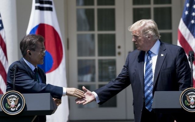 South Korea's President Moon Jae-in and US President Donald Trump shake hands while making statements in the Rose Garden of the White House June 30, 2017 in Washington, DC. (AFP PHOTO / Brendan Smialowski)