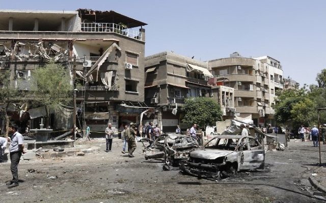 Syrians inspect the site of a suicide bomb attack in Damascus on July 2, 2017. (AFP Photo/Louai Beshara) Syrians inspect the site of a suicide bomb attack in Damascus on July 2, 2017. (AFP Photo/Louai Beshara)