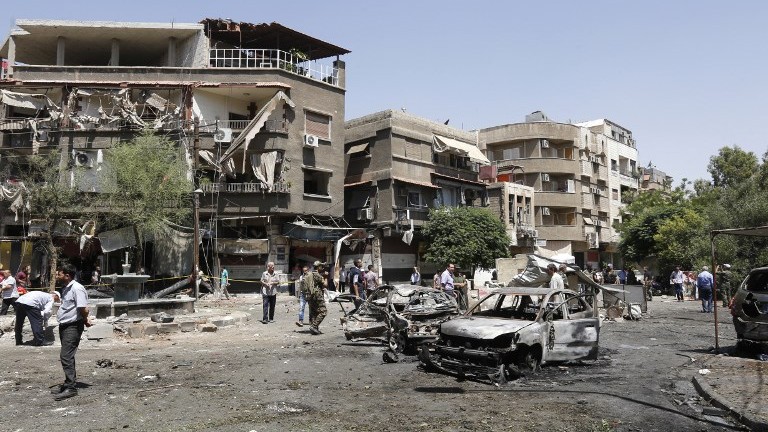 Syrians inspect the site of a suicide bomb attack in Damascus on July 2, 2017. (AFP Photo/Louai Beshara) Syrians inspect the site of a suicide bomb attack in Damascus on July 2, 2017. (AFP Photo/Louai Beshara)