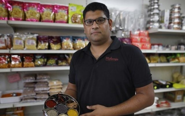 Elazar Ashtivker, owner of the Maharaja Indian restaurant in the small city of Ramla, south of Tel Aviv, poses for a photo with spices at his restaurant on July 2, 2017, as the Jewish Indian community prepare for the visit of the Indian prime minister. (AFP/ MENAHEM KAHANA)
