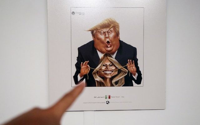 A picture taken on July 3, 2017 shows a cartoon of US President Donald Trump and First Lady Melania Trump on display at an exhibition of Iran's 2017 International Trumpism cartoon and caricature contest, in the capital Tehran.  (ATTA KENARE/AFP)