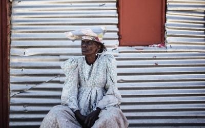 Namibian woman Sarafia Komomungondo siits by a corrugated iron shack on the outskirts of the impoverished Namibian town of Okakarara on June 22, 2017. (AFP Photo/Gianluigi Guercia)