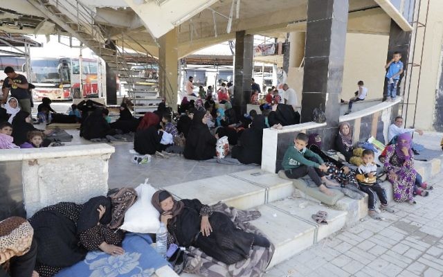 Displaced Syrians who fled with their families Islamic State controlled areas in Raqqa, Deir Ezzor and Mayadeen gather at Aleppo's bus station of Ramussa on July 4, 2017. (AFP PHOTO / JOSEPH EID) Displaced Syrians who fled with their families Islamic State controlled areas in Raqqa, Deir Ezzor and Mayadeen gather at Aleppo's bus station of Ramussa on July 4, 2017. (AFP PHOTO / JOSEPH EID)