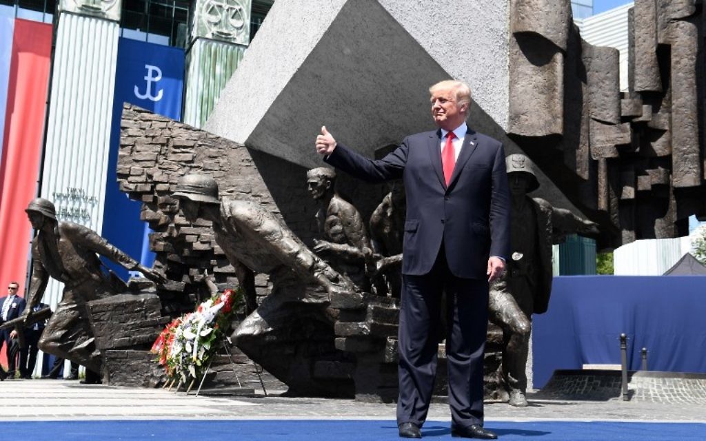 US President Donald Trump holds his thumb up as he poses in front of the Warsaw Uprising Monument on Krasinski Square on the sidelines of the Three Seas Initiative Summit in Warsaw, Poland, July 6, 2017. (AFP/SAUL LOEB)