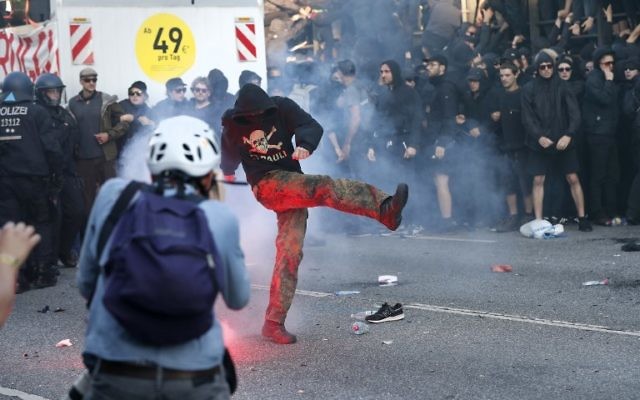 Flares are thrown at Riot police during the "Welcome to Hell" rally against the G20 summit in Hamburg, northern Germany on July 6, 2017. (AFP/Odd ANDERSEN)