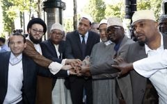 Illustrative image of the Imam of Drancy, Hassen Chalghoumi (C), Lebanese Imam Mohammad Ali Al-Husseini (2L) Egyptian Sheikh Ahmed Mohamed el-Tayeb (3R) posing with others as they prepare to take part in The Muslim March Against Terrorism in Paris on July 8, 2017. (AFP/Francois Guillot)