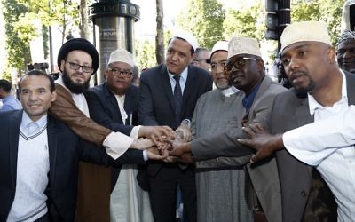 Illustrative image of the Imam of Drancy, Hassen Chalghoumi (C), Lebanese Imam Mohammad Ali Al-Husseini (2L) Egyptian Sheikh Ahmed Mohamed el-Tayeb (3R) posing with others as they prepare to take part in The Muslim March Against Terrorism in Paris on July 8, 2017. (AFP/Francois Guillot)