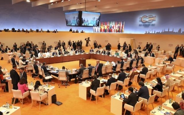 General view shows participants of the G20 taking their seats at the beginning of their third working session of the G20 meeting in Hamburg, northern Germany, on July 8, 2017. (AFP PHOTO AND POOL / Ludovic MARIN / SOLELY FOR REUTERS AND EPA)