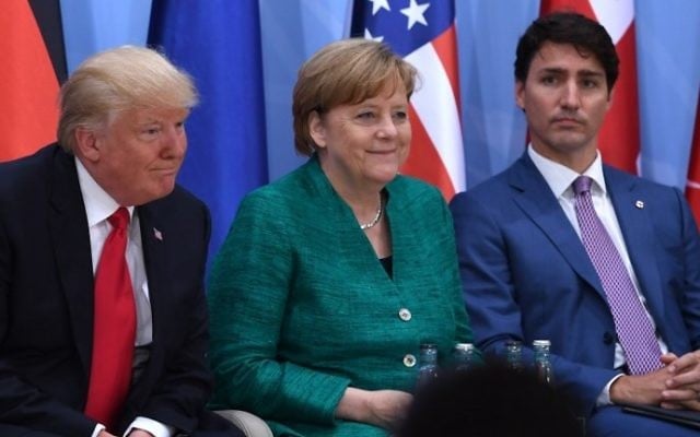 From left to right: US President Donald Trump, German Chancellor Angela Merkel and Canada's Prime Minister Justin Trudeau on the second day of the G20 Summit in Hamburg, Germany, July 8, 2017. (AFP/Pool/Patrik Stollarz) From left to right: US President Donald Trump, German Chancellor Angela Merkel and Canada's Prime Minister Justin Trudeau on the second day of the G20 Summit in Hamburg, Germany, July 8, 2017. (AFP/Pool/Patrik Stollarz)