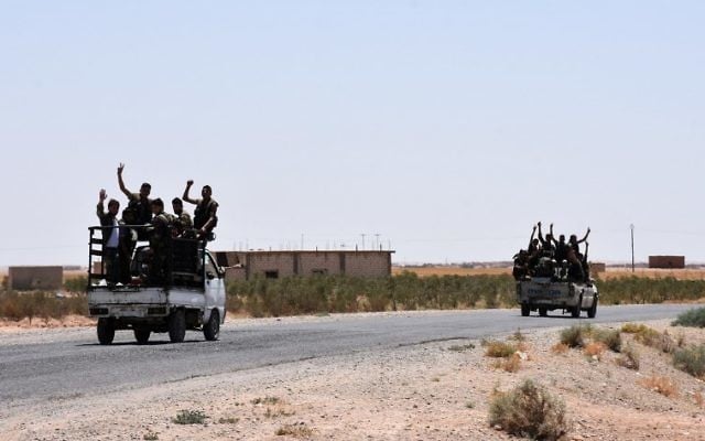 Members of the Syrian pro-government forces riding in vehicles on the road near the Syrian village of Hanna Safar, on the western outskirts of Raqa province, July 8, 2017. (AFP/George OURFALIAN) Members of the Syrian pro-government forces riding in vehicles on the road near the Syrian village of Hanna Safar, on the western outskirts of Raqa province, July 8, 2017. (AFP/George OURFALIAN)