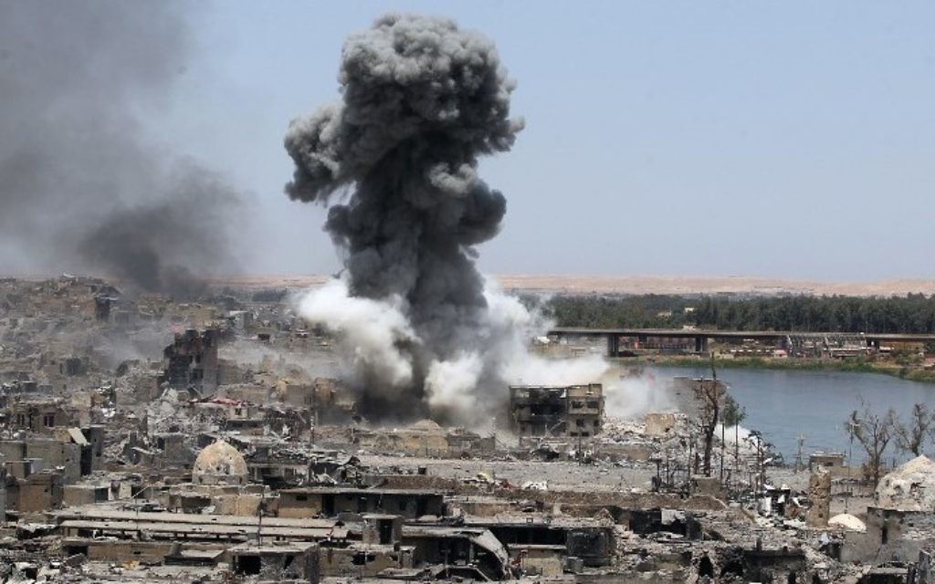 Illustrative: A picture taken on July 9, 2017, shows smoke billowing following an airstrike by US-led international coalition forces targeting Islamic State (IS) group in Mosul. (AFP/Ahmad Al-Rubaye)