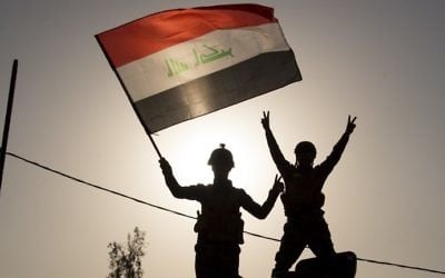 Iraq's federal police members wave an Iraqi flag as they celebrate in the Old City of Mosul on July 9, 2017. (AFP Photo/Fadel Senna)
