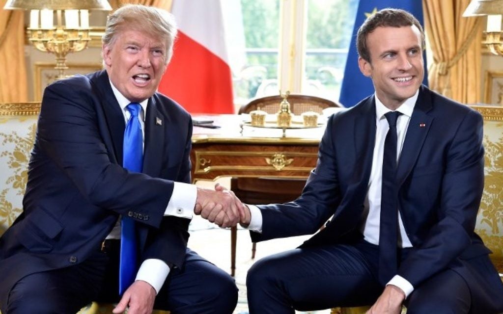 French President Emmanuel Macron (R) shakes hands with US President Donald Trump (L) during a meeting at the Elysee Palace in Paris on July 13, 2017. (AFP Photo/Pool/Alain Jocard)