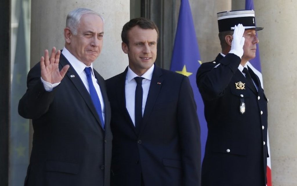 File: Prime Minister Benjamin Netanyahu, left, waves as he stands next to French President Emmanuel Macron, right, upon his arrival at the Elysee Palace, in Paris, on July 15, 2017 ahead of their meeting. (AFP Photo/Geoffroy Van Der Hasselt)