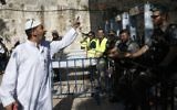 A Palestinian man argues with Israeli border policemen standing guard near newly-installed metal detectors at a main entrance to the Al-Aqsa mosque compound in Jerusalem's Old City,  July 16, 2017, after security forces reopened the ultra-sensitive site. (AFP PHOTO / AHMAD GHARABLI)