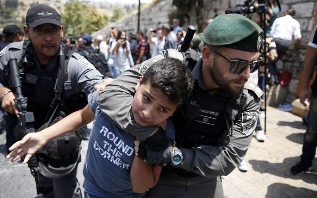Israeli border guards detain a young protester during a demonstration outside the Lions Gate in Jerusalem's Old City on July 17, 2017. (AFP Photo/Ahmad Gharabli) Israeli border guards detain a young protester during a demonstration outside the Lions Gate in Jerusalem's Old City on July 17, 2017. (AFP Photo/Ahmad Gharabli)