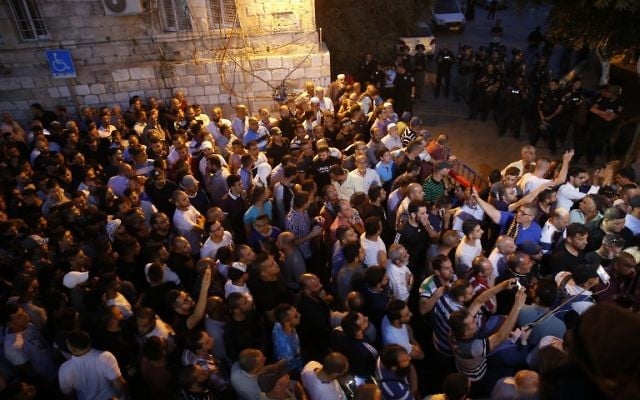 Palestinian Muslim worshipers demonstrate next to Lions Gate in Jerusalem's Old City on July 18, 2017.(AFP/ AHMAD GHARABLI)