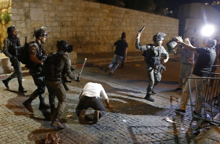 Israeli security forces clash with Palestinian demonstrators outside the Lion's Gate in Jerusalem's Old City on July 18, 2017. (AFP/Ahmad Gharabli) Israeli security forces clash with Palestinian demonstrators outside the Lion's Gate in Jerusalem's Old City on July 18, 2017. (AFP/Ahmad Gharabli)