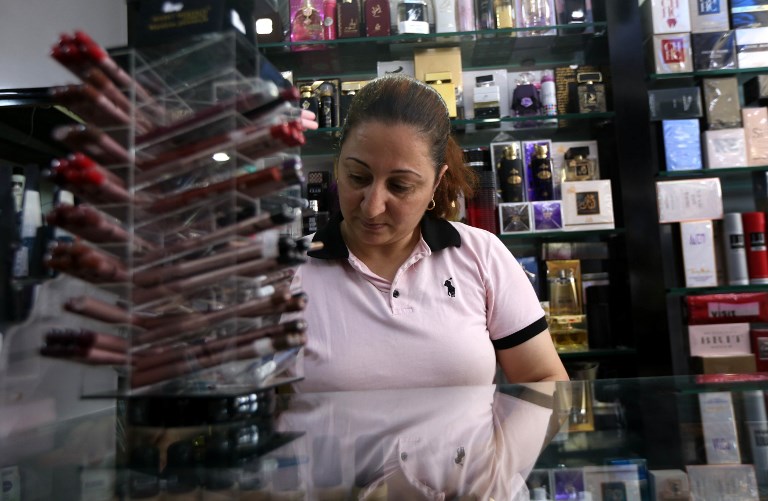 Samaher Kiriakos Hanna, a 37-year-old Orthodox Christian who fled the violence in the small, mainly Christian town of Bartalla, near Mosul, after Islamic State (IS) group militants seized control of the area, works as a shop assistant at a clothing and cosmetics store in Arbil, the capital of the autonomous Kurdish region of northern Iraq, on July 20, 2017. (AFP PHOTO / SAFIN HAMED) Samaher Kiriakos Hanna, a 37-year-old Orthodox Christian who fled the violence in the small, mainly Christian town of Bartalla, near Mosul, after Islamic State (IS) group militants seized control of the area, works as a shop assistant at a clothing and cosmetics store in Arbil, the capital of the autonomous Kurdish region of northern Iraq, on July 20, 2017. (AFP PHOTO / SAFIN HAMED)
