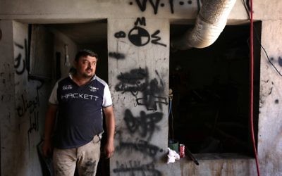 Haitham Behnam, a 34-year-old Iraqi Christian man who fled the violence in Mosul after Islamic State (IS) group militants seized control of the northern Iraqi city, stands at his auto repair workshop where he works as a mechanic in Arbil, the capital of the autonomous Kurdish region of northern Iraq, on July 20, 2017. (AFP PHOTO / SAFIN HAMED)