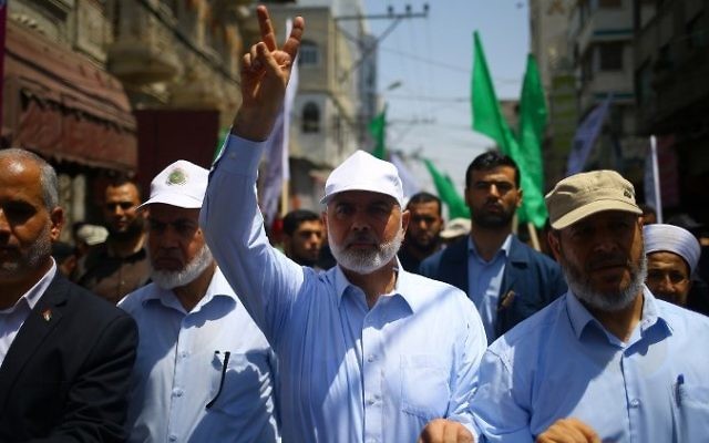 Hamas leader Ismail Haniyeh, center, and spokesman Fawzi Barhoum attend a protest in Gaza City on July 22, 2017, against new Israeli security measures implemented at the holy site, which include metal detectors and cameras, following an attack that killed two Israeli policemen the previous week. (AFP/Mohammed Abed) Hamas leader Ismail Haniyeh, center, and spokesman Fawzi Barhoum attend a protest in Gaza City on July 22, 2017, against new Israeli security measures implemented at the holy site, which include metal detectors and cameras, following an attack that killed two Israeli policemen the previous week. (AFP/Mohammed Abed)