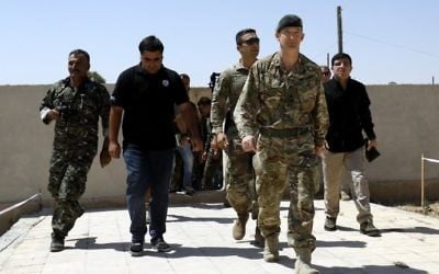 Rupert Jones (2nd-L), deputy commander of Combined Joint Task Force Operation Inherent Resolve (CJTF-OIR), arrives for a meeting with the Raqqa Civil Council on July 23, 2017, in the northern Syrian village of Ain Issa. (AFP Photo/Delil Souleiman)