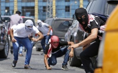 Palestinian protesters clash with Israeli security forces near the Jewish settlement of Beit El, near the West Bank city of Ramallah, on July 24, 2017. (AFP/Abbas Momani)
