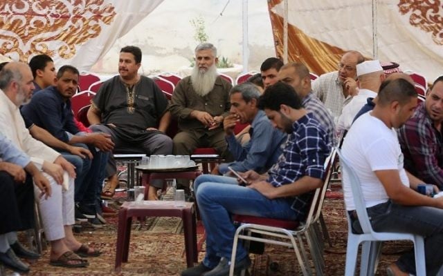 Relatives of 17-year-old Mohammed Jawawdeh, who was shot dead by an Israeli security guard after he attacked him with a screwdriver at the Israeli embassy compound, gather in a mourning tent in the capital Amman on July 24, 2017. (AFP / KHALIL MAZRAAWI)