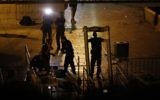 Israeli security forces take down metal detectors at the Lions Gate, near a main entrance to the Temple Mount in Jerusalem's Old City, on July 24, 2017. (AFP/ Ahmad Gharabli)