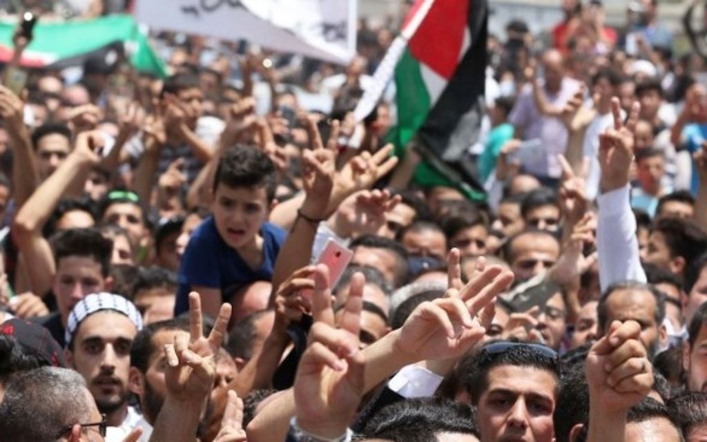 Mourners attend the funeral of 17-year-old Mohammed Jawawdeh, who was killed when he allegedly attacked a security guard at the Israeli embassy compound in the Jordanian capital with a screwdriver, on July 25, 2017, in Amman. (Khalil Mazraawi/AFP)