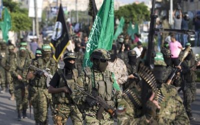 Palestinian members of the Izz ad-Din al-Qassam Brigades, the armed wing of the Hamas terror movement, take part in a military parade against Israel in Gaza City, July 25, 2017. (AFP/Mahmud Hams)