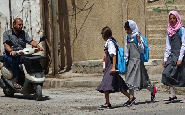 Iraqi girls walk to school in west Mosul on July 27, 2017. (AFP/Safin Hamed) Iraqi girls walk to school in west Mosul on July 27, 2017. (AFP/Safin Hamed)
