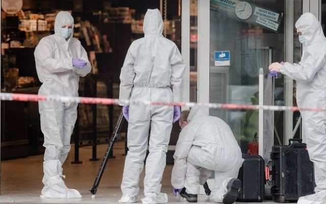 Police investigator work at the area around a supermarket in the northern German city of Hamburg, where a man killed one person and wounded several others in a knife attack, on July 28, 2017. (AFP/dpa/Markus Scholz) Police investigator work at the area around a supermarket in the northern German city of Hamburg, where a man killed one person and wounded several others in a knife attack, on July 28, 2017. (AFP/dpa/Markus Scholz)