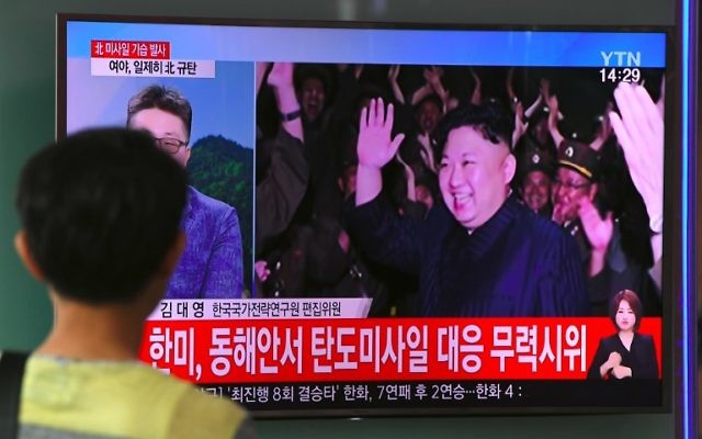 A man watches a television screen showing a video footage of North Korean leader Kim Jong-Un celebrating his country's latest test launch of an intercontinental ballistic missile (ICBM), at a railway station in Seoul on July 29, 2017.(AFP PHOTO / JUNG Yeon-Je)