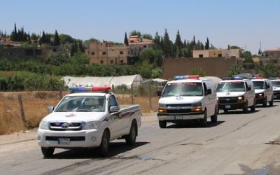 A picture taken on July 30, 2017 in the al-Labweh village, part of the Baalbek-Hermel governorate, shows an ambulance convoy of the Lebanese Shiite Hezbollah movement carrying bodies of fighters killed in week-long clashes in the Jurud Arsal border region, as part of a ceasefire deal. (AFP/Stringer)
