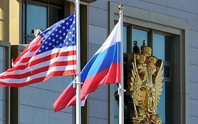 This photo taken on May 7, 2013 shows Russian and the US flags running up as the US Secretary of State arrives at Moscow Vnukovo Airport. (Mladen Antonov/AFP)