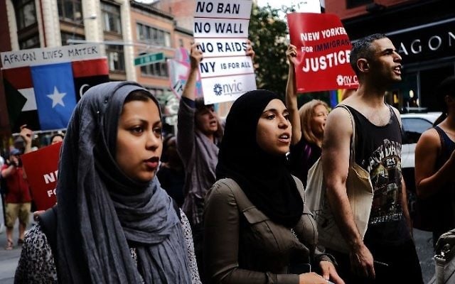 Recent Immigrants join activists for an evening protest in Manhattan hours before a revised version of President Donald Trump's travel ban that was approved by the Supreme Court took effect on June 29, 2017 in New York City (Spencer Platt/Getty Images/AFP) Recent Immigrants join activists for an evening protest in Manhattan hours before a revised version of President Donald Trump's travel ban that was approved by the Supreme Court took effect on June 29, 2017 in New York City (Spencer Platt/Getty Images/AFP)