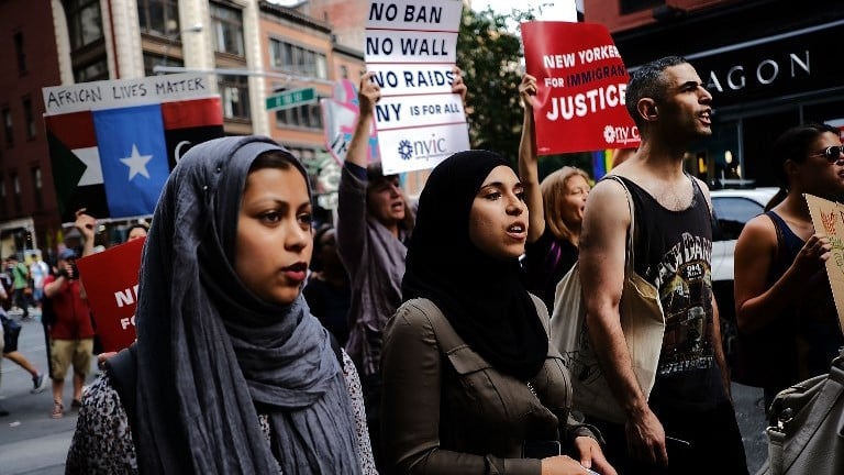 Recent Immigrants join activists for an evening protest in Manhattan hours before a revised version of US President Donald Trump's travel ban that was approved by the Supreme Court is to take effect on June 29, 2017 in New York City. (Spencer Platt/Getty Images/AFP) Recent Immigrants join activists for an evening protest in Manhattan hours before a revised version of US President Donald Trump's travel ban that was approved by the Supreme Court is to take effect on June 29, 2017 in New York City. (Spencer Platt/Getty Images/AFP)
